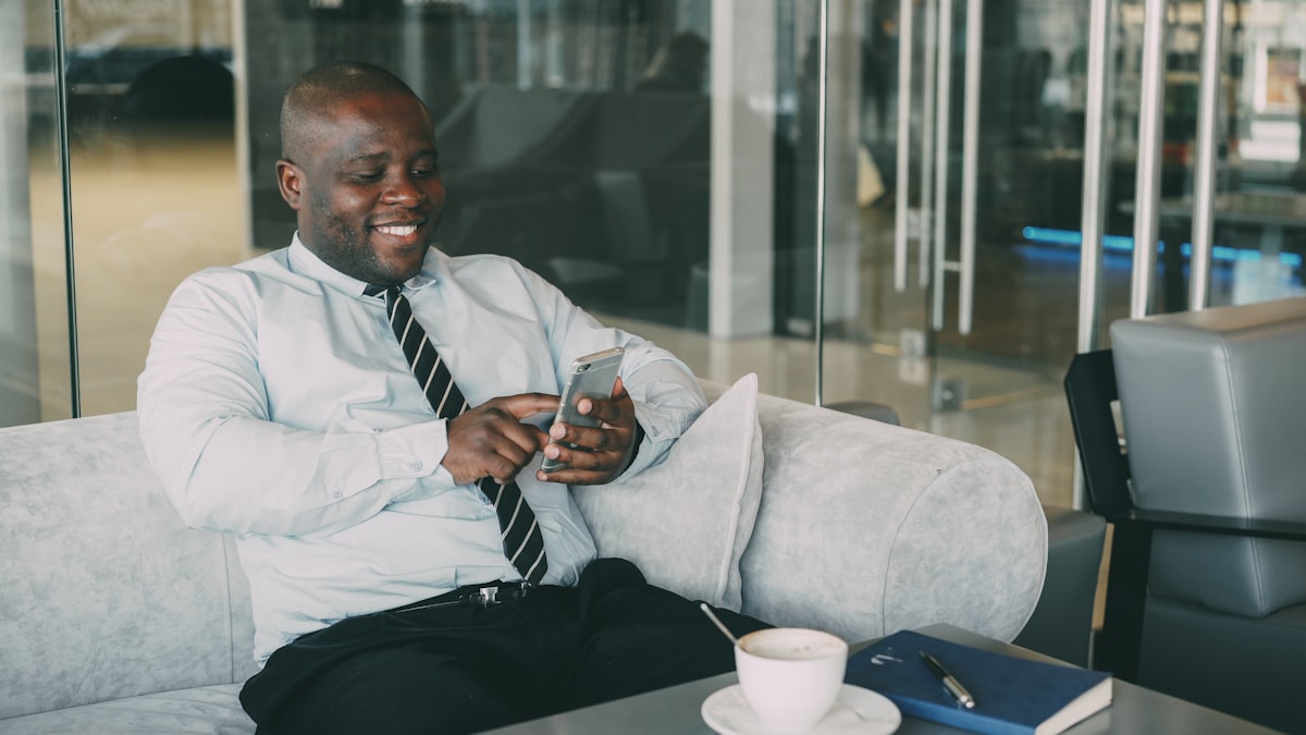 A professional smiling while using Talentta on WhatsApp on his phone