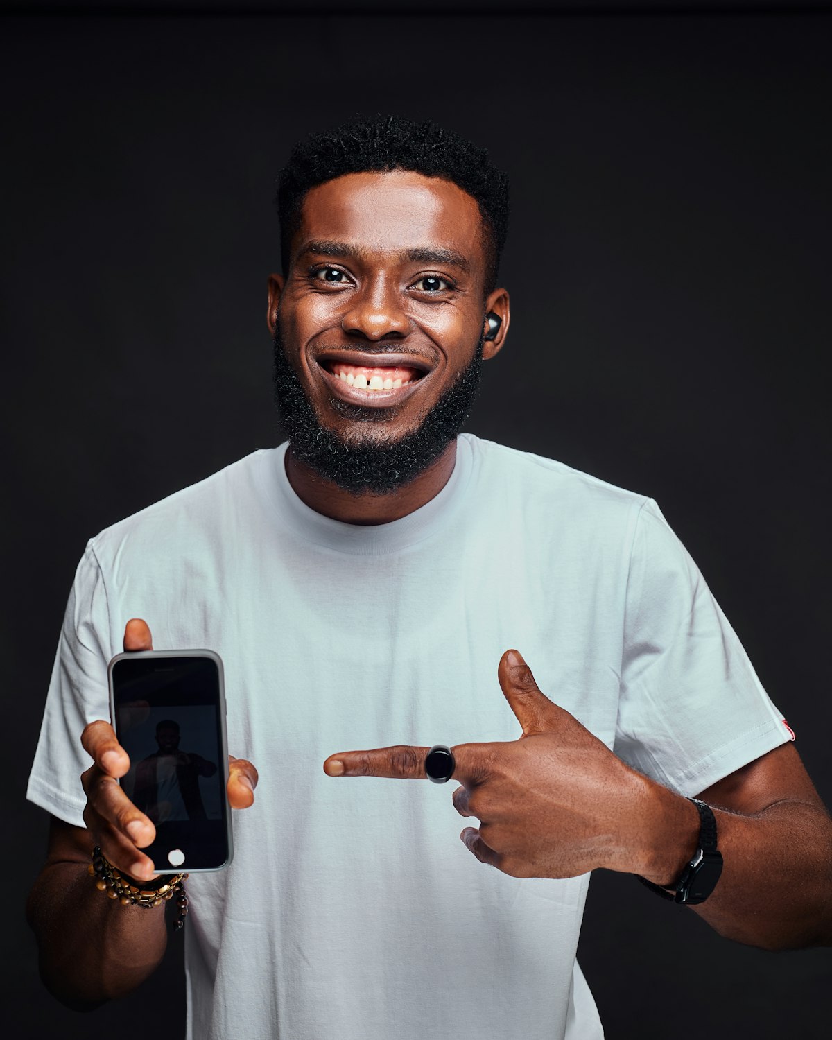 An employer smiling and pointing at a job posted through Talentta on WhatsApp